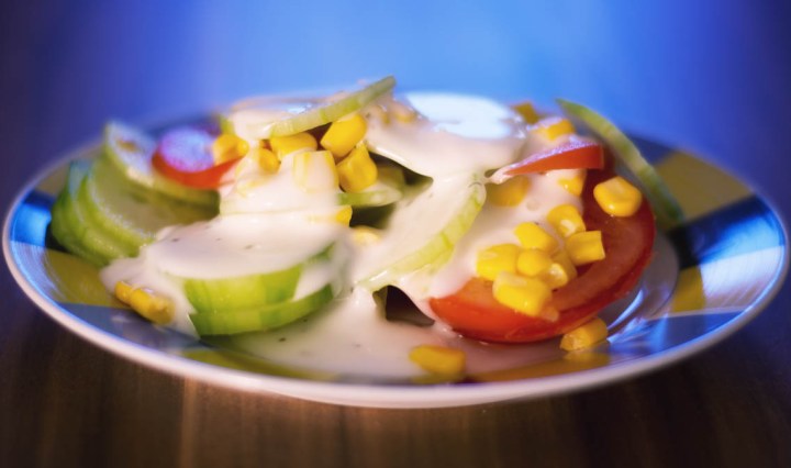 Fresh salad with cucumber, tomato, maize and garlic sauce