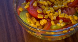 Fresh salad with cucumber, tomato, maize and garlic sauce