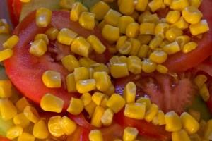 Fresh salad with cucumber, tomato, maize and garlic sauce