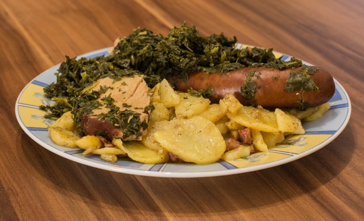 Kale with fried potatoes, smoked pork chop and smoked sausage