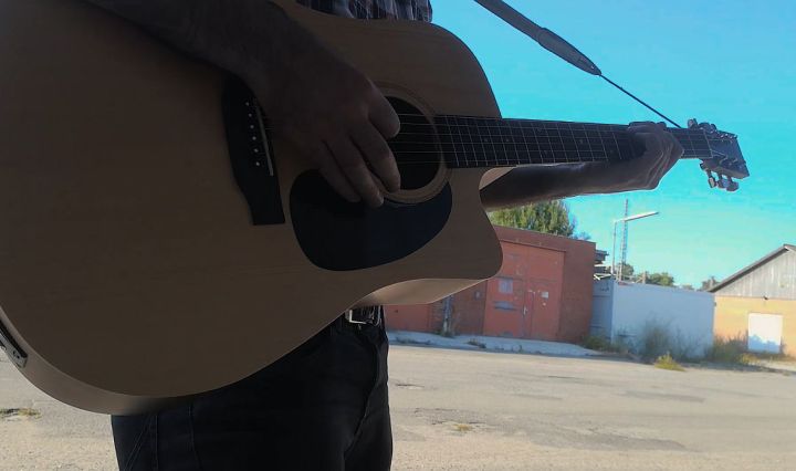playing acoustic guitar outside